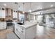 Modern kitchen with white cabinets, large island, and stainless steel appliances at 29762 N 69Th Ln, Peoria, AZ 85383