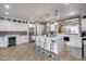 Open kitchen with white cabinets, center island, and views into the living room at 29762 N 69Th Ln, Peoria, AZ 85383