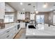 Modern kitchen with white cabinets, quartz countertops, and stainless steel appliances at 29762 N 69Th Ln, Peoria, AZ 85383