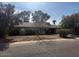 Single story home with a large front yard and mature trees at 3021 E Windrose Dr, Phoenix, AZ 85032