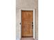 Close-up of a wood condo entry door at 3031 N Civic Center Plz # 317, Scottsdale, AZ 85251