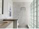 Spa-like bathroom with marble tile, glass block shower, and modern fixtures at 320 W Cypress St, Phoenix, AZ 85003