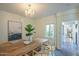 Dining room with wooden table, view into kitchen and access to backyard through French doors at 320 W Cypress St, Phoenix, AZ 85003