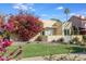 Charming curb appeal with lush bougainvillea and well-manicured lawn at 320 W Cypress St, Phoenix, AZ 85003