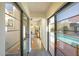 Hallway with glass doors offering views to the living room and backyard pool at 320 W Cypress St, Phoenix, AZ 85003