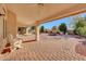 Covered patio with brick pavers, a desert landscape and seating area at 3439 E Topeka Dr, Phoenix, AZ 85050