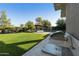 Well-manicured backyard features a built-in outdoor kitchen and entertainment area with a pool at 350 W Yellowstone Way, Chandler, AZ 85248