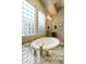 Serene bathroom showcases a soaking tub, glass block windows, and tiled accents at 350 W Yellowstone Way, Chandler, AZ 85248