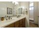 Bathroom with a double sink vanity, large mirror, and a separate door to the shower and toilet at 350 W Yellowstone Way, Chandler, AZ 85248