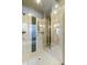 Bathroom with a tiled shower featuring glass doors, built-in bench, and multiple shower heads at 350 W Yellowstone Way, Chandler, AZ 85248