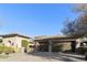 A home showcasing a three-car garage with dark wood doors, complemented by desert landscaping at 350 W Yellowstone Way, Chandler, AZ 85248