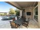 Covered patio featuring an iron table, seating, and a backyard pool with a waterfall at 350 W Yellowstone Way, Chandler, AZ 85248