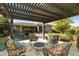 Outdoor sitting area under a pergola with comfortable chairs and a fire pit at 350 W Yellowstone Way, Chandler, AZ 85248