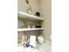 Close-up of white shelving with decor accents in a neutral kitchen space at 350 W Yellowstone Way, Chandler, AZ 85248