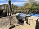 Outdoor kitchen with built-in grill and patio umbrella at 3652 N Sonoran Hts, Mesa, AZ 85207