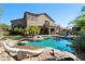 Sprawling backyard featuring a pool, outdoor kitchen, and mature palms for an entertainer's dream at 3652 N Sonoran Hts, Mesa, AZ 85207