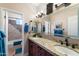 Double vanity bathroom featuring granite countertops, dark wood cabinets, and decorative fixtures at 3652 N Sonoran Hts, Mesa, AZ 85207