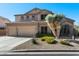 Charming two-story home with a three-car garage, beautiful landscaping, and mature desert plants at 3652 N Sonoran Hts, Mesa, AZ 85207