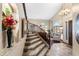 Elegant foyer with a grand staircase, travertine floors, and high ceilings leading to the living areas at 3652 N Sonoran Hts, Mesa, AZ 85207