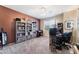 A bright office space with built in shelving, and neutral carpet with a large window for natural light at 3652 N Sonoran Hts, Mesa, AZ 85207