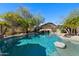 Sparkling pool features a waterfall, rock features, and desert landscaping, creating a relaxing outdoor oasis at 3652 N Sonoran Hts, Mesa, AZ 85207