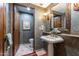 Bathroom with pedestal sink, granite vanity, and tiled floor at 36601 N Mule Train Rd # B40, Carefree, AZ 85377