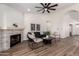 Living room with stone fireplace, comfortable seating, and hardwood floors at 3743 W Shannon St, Chandler, AZ 85226