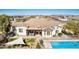 Aerial view of a home with a covered patio, lush green grass, and a sparkling blue pool at 3791 E Vista Grande Dr, San Tan Valley, AZ 85140