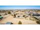 Wide aerial view of a sprawling property with a large main house, horse facilities and desert landscaping at 3791 E Vista Grande Dr, San Tan Valley, AZ 85140