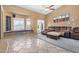 Cozy living room features a ceiling fan, window seating and a comfortable brown sofa at 3791 E Vista Grande Dr, San Tan Valley, AZ 85140