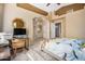 Bright main bedroom featuring a workspace, tiled floors and an ensuite bathroom with neutral tones at 3791 E Vista Grande Dr, San Tan Valley, AZ 85140