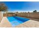 Backyard pool surrounded by concrete patio and block fence, perfect for outdoor relaxation at 3791 E Vista Grande Dr, San Tan Valley, AZ 85140