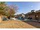 Inviting backyard with sparkling pool, covered patio, and lush landscaping at 3910 W Michigan Ave, Glendale, AZ 85308