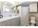 Bathroom with gray vanity, shower, and white toilet at 3910 W Michigan Ave, Glendale, AZ 85308