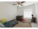 Well-lit bedroom with a twin bed, dresser, and large window at 3910 W Michigan Ave, Glendale, AZ 85308