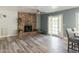 Living room features a brick fireplace and wood-look floors at 3910 W Michigan Ave, Glendale, AZ 85308