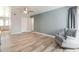 Bright living room with hardwood floors and a comfy armchair at 3910 W Michigan Ave, Glendale, AZ 85308