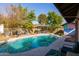 Backyard with a sparkling pool, patio area, and storage shed at 3910 W Michigan Ave, Glendale, AZ 85308