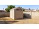 Tan colored storage shed with double doors at 3910 W Michigan Ave, Glendale, AZ 85308