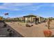 Spacious backyard with gravel landscaping, artificial turf, and pergola at 42157 W Cribbage Rd, Maricopa, AZ 85138