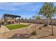 Landscaped backyard with artificial turf and a pergola at 42157 W Cribbage Rd, Maricopa, AZ 85138