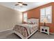 Well-lit bedroom with a white wooden bed frame and two nightstands at 42157 W Cribbage Rd, Maricopa, AZ 85138