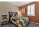 Cozy bedroom with a wooden bed frame and window with shutters at 42157 W Cribbage Rd, Maricopa, AZ 85138