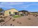 Back exterior view of house showcasing a hot tub and patio at 42157 W Cribbage Rd, Maricopa, AZ 85138