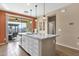 Eat-in kitchen with island, white cabinets, and sliding door to patio at 42157 W Cribbage Rd, Maricopa, AZ 85138