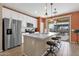 Modern kitchen featuring a large island with seating and stainless steel appliances at 42157 W Cribbage Rd, Maricopa, AZ 85138