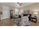 Living room with a ceiling fan, comfortable seating, and hardwood floors at 42157 W Cribbage Rd, Maricopa, AZ 85138