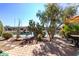 Landscaped backyard with lake view and patio seating at 42621 W Heavenly Pl, Maricopa, AZ 85138