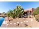 Landscaped backyard with desert plants and pond views at 42621 W Heavenly Pl, Maricopa, AZ 85138