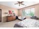 Bedroom with king-size bed, dresser, and ceiling fan at 42621 W Heavenly Pl, Maricopa, AZ 85138